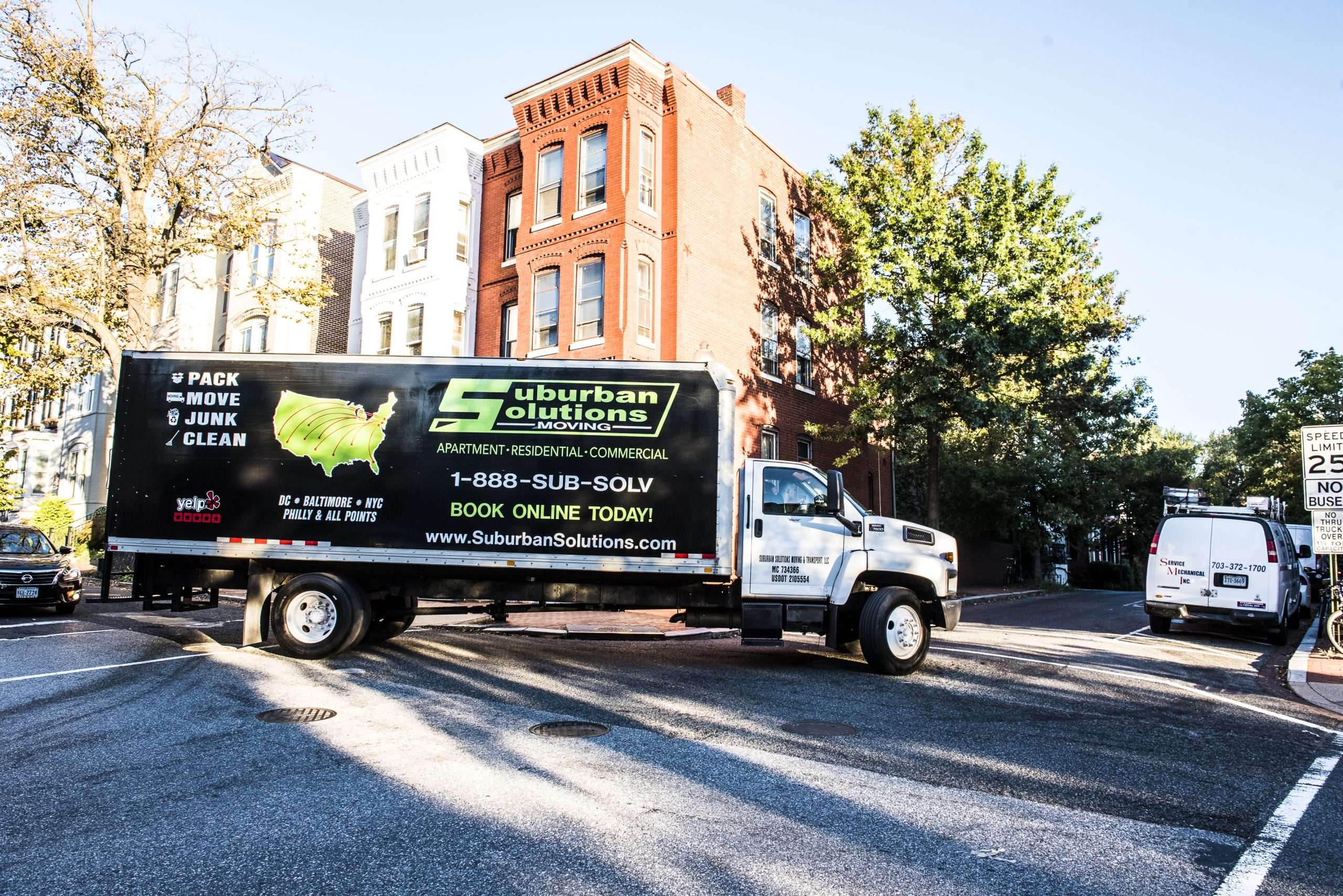 Suburban Solutions moving truck parked outside a residential area in Herndon.